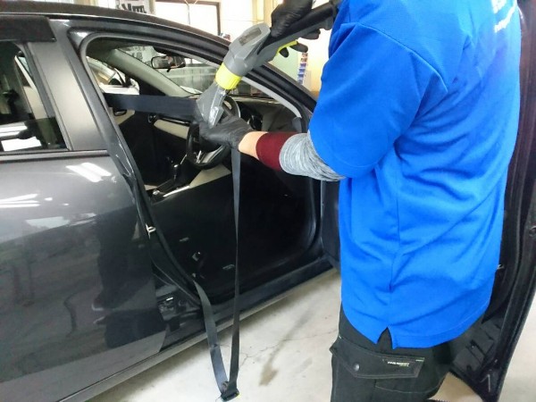 デミオ・プレミアム車内クリーニング・シートベルトをクリーニング中